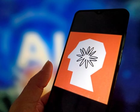 person holds phone with anthropic logo