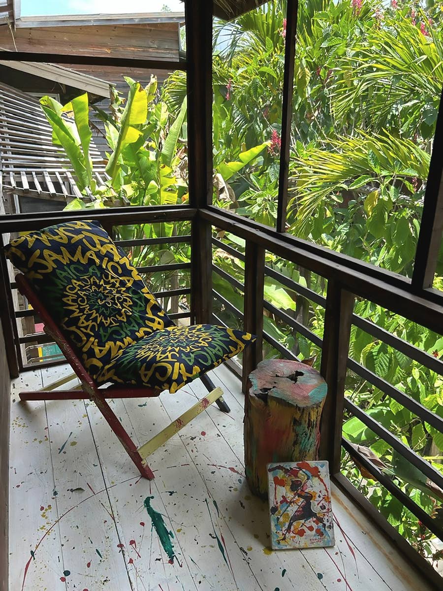 Colourfully splash-painted balconies emerge from the lush foliage, revealing sweeping views of the sea.